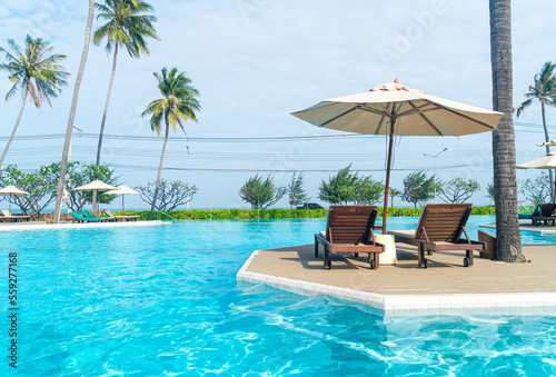 umbrella with bed pool around swimming pool with ocean sea background