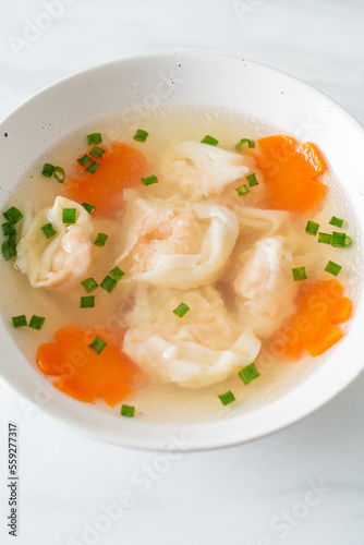 shrimp dumpling soup in white bowl