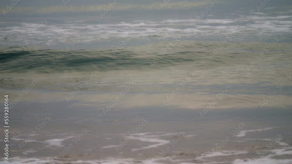Waves at sunrise in slow motion. The morning colors are reflected in the water. Waves at sunrise in slow motion. The morning colors are reflected in the water.