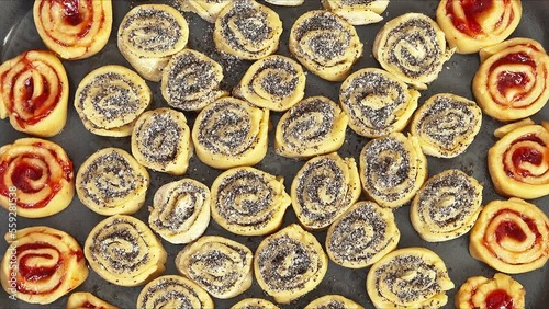 Wallpaper Mural Appetizing homemade cookies in the form of rolls with poppy seeds and jam at tray ready for baking. Movement with rotation. Edible background. Close-up, flat lay, mock up, top view Torontodigital.ca