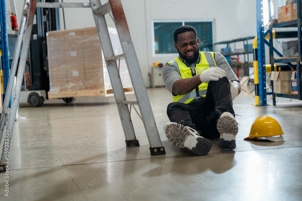 An African worker had an accident while working in a warehouse. An African worker had an accident while working in a warehouse.