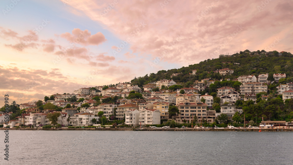 View of the mountains of Kinaliada island from Marmara Sea, with traditional summer houses and boats, Istanbul, Turkey, at sunrise