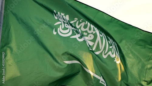 Close-up Saudi Arabia national flag waving in the wind against sunset, Slow Motion. Concept of Celebration, Saudi Arabia, Flag, National, Independence Day, Patriot photo