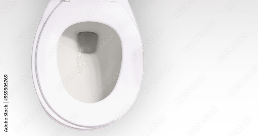 Close up to a toilet bowl while it is flushing toilet paper waste. 