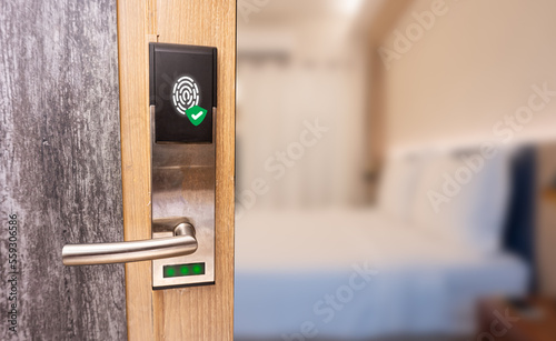 Fingerprint smart door system with bedroom background. Technology of security in hotel concept.