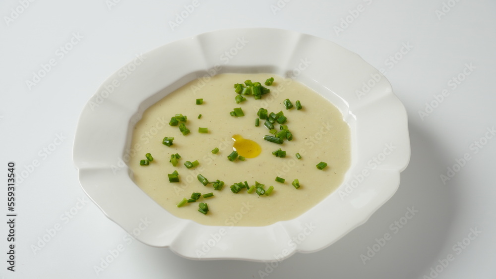 Vichyssoise, classic French chilled cream soup - potato leek, and onion topped with chopped chives Vichyssoise, classic French chilled cream soup - potato leek, and onion topped with chopped chives