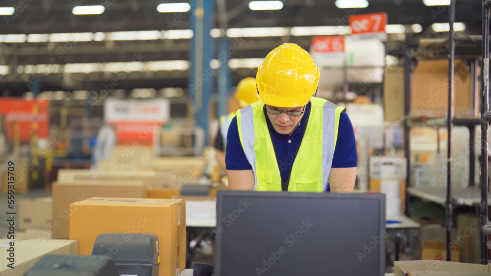 Portrait of Asian man worker working in large warehouse retail store industry factory. Rack of stock storage. Cargo in ecommerce and logistic concept. Depot. People lifestyle. Shipment service. Portrait of Asian man worker working in large warehouse retail store industry factory. Rack of stock storage. Cargo in ecommerce and logistic concept. Depot. People lifestyle. Shipment service.