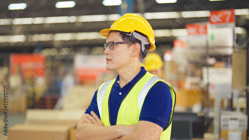 Portrait of Asian man worker working in large warehouse retail store industry factory. Rack of stock storage. Cargo in ecommerce and logistic concept. Depot. People lifestyle. Shipment service.