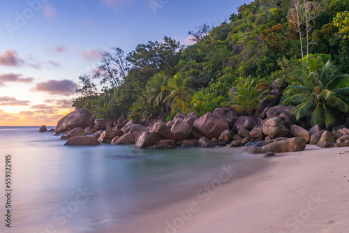 Long exposure image of the dusk on beautiful and cozy Petite Anse beach on Praslin island, Seychelles