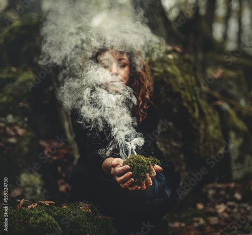 Shaman woman and incense in her hands, incense in a woman hand, ceremony space.