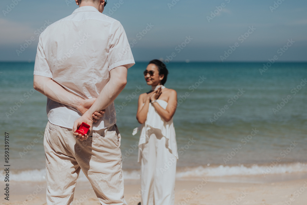Romantic couple love propose marriage on the beach. Young man surprising marriage with girlfriend on summer vacation. honeymoon lifestyle, Happy aniversary.