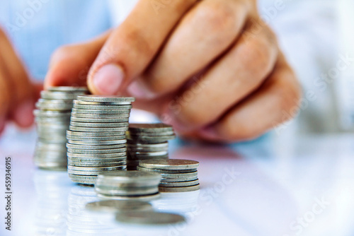 Hand put coin to stack, investment concept