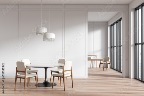 Front view on bright dining room interior with armchairs  table
