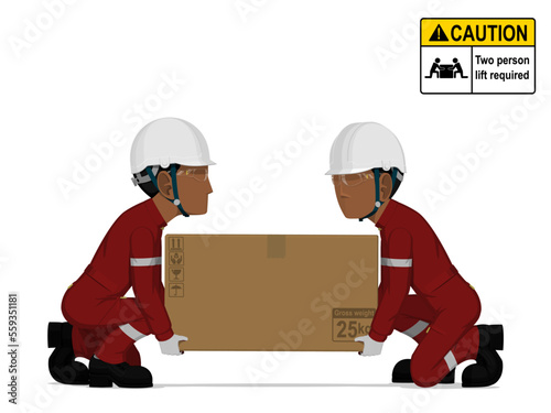 Two workers is lifting a big box on the floor