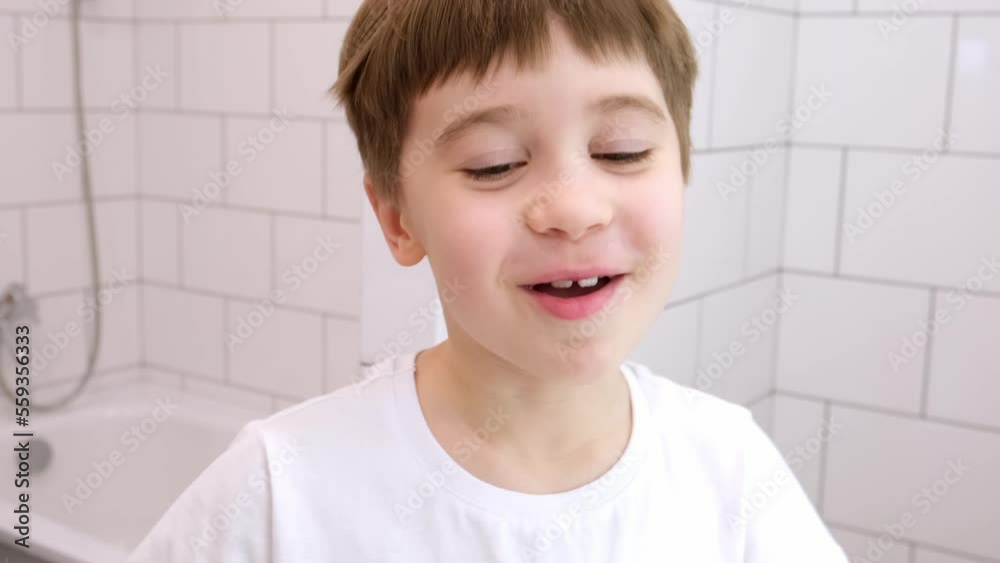 Happy smiling child looking at the camera speak something. Cute caucasian 6 year old boy in white t-shirt. Close-up portrait. Concept of happiness and good mood. Cheerful and joyful kid. Pretty face. Happy smiling child looking at the camera speak something. Cute caucasian 6 year old boy in white t-shirt. Close-up portrait. Concept of happiness and good mood. Cheerful and joyful kid. Pretty face.