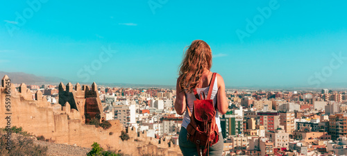 Woman tourist looking at panoramic view of Almeria city in Spain