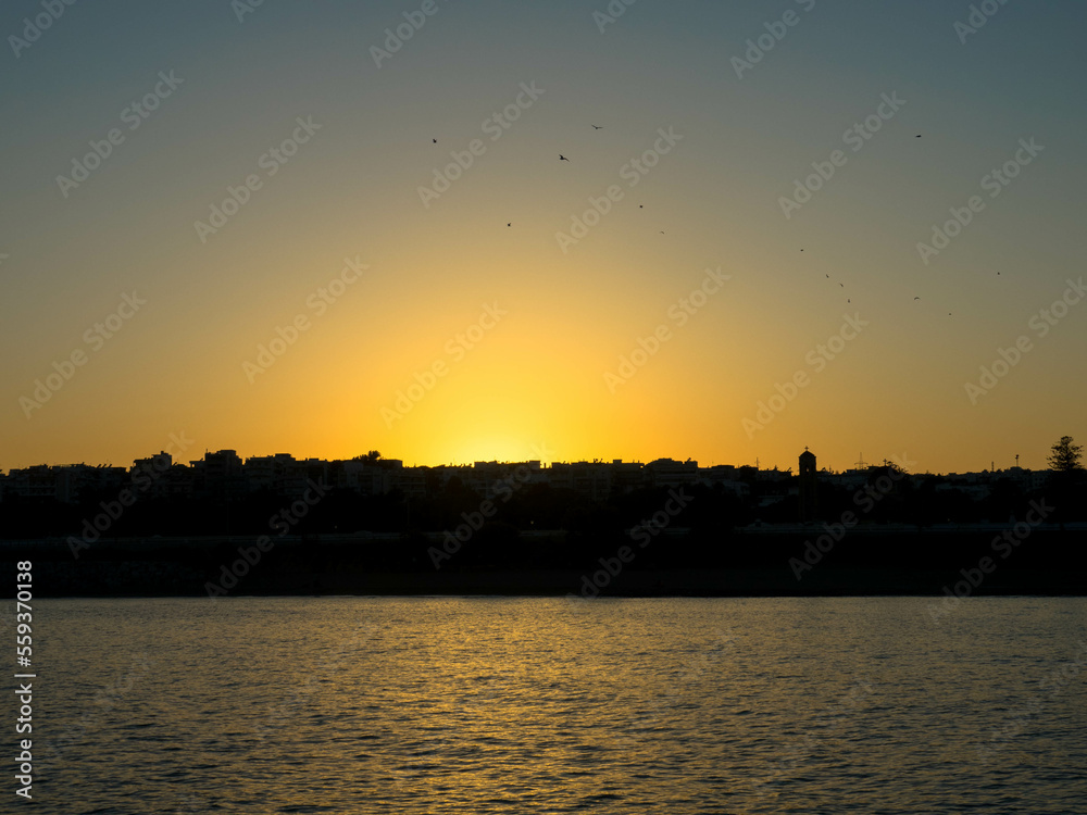 Panoramic view. Sunset over Rhodes town and port. Beautiful sky with space for text.
