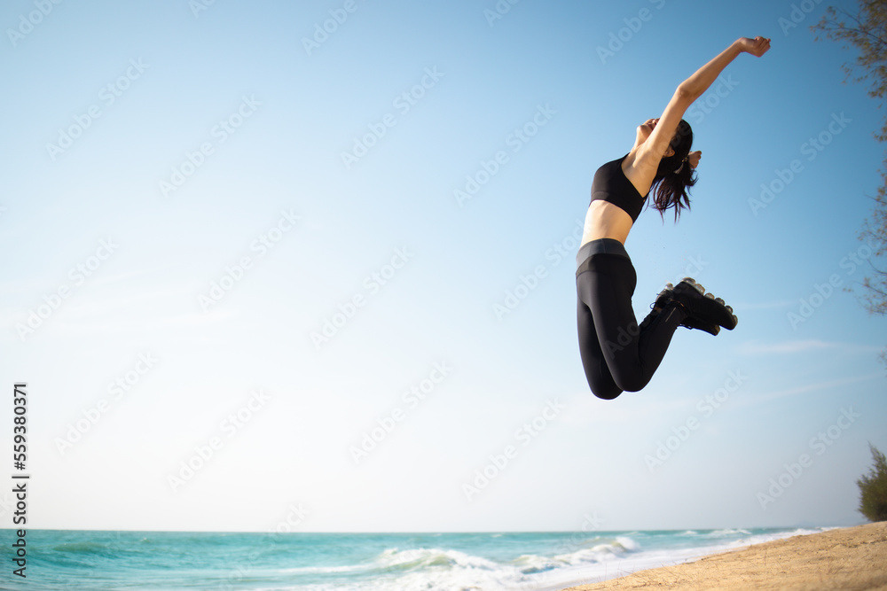 Athlete sport female happy jumping exercise workout on the beach in day time, Wellness, training and warm up athlete on the coast to start running Athlete sport female happy jumping exercise workout on the beach in day time, Wellness, training and warm up athlete on the coast to start running