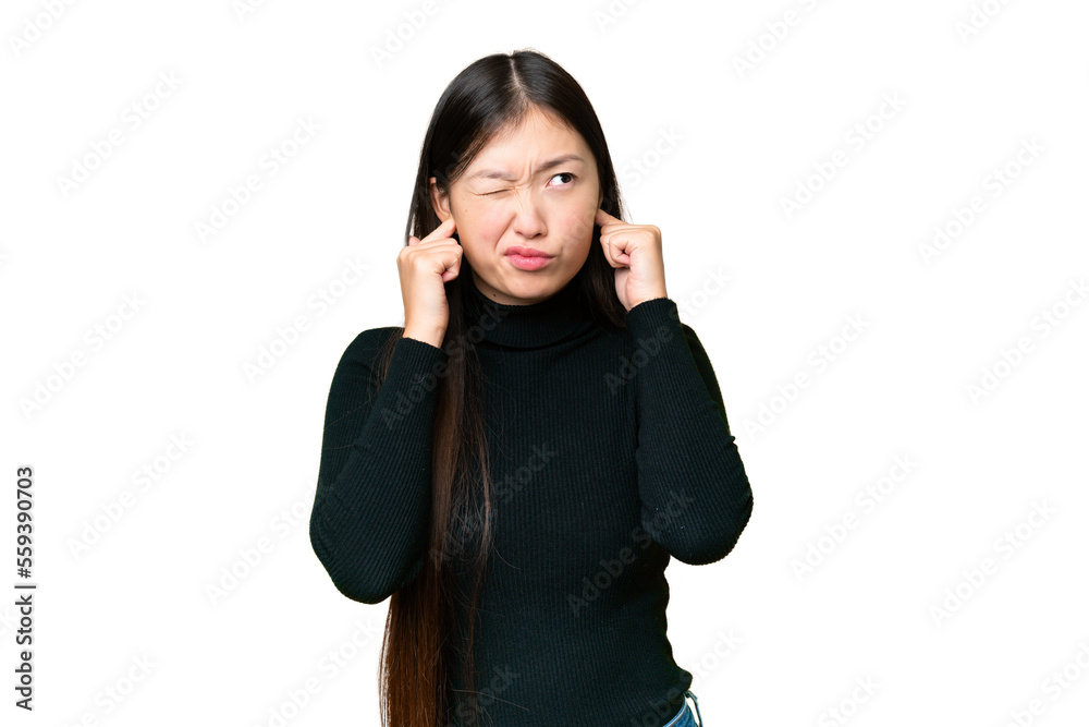 Young Asian woman over isolated chroma key background frustrated and covering ears Young Asian woman over isolated chroma key background frustrated and covering ears