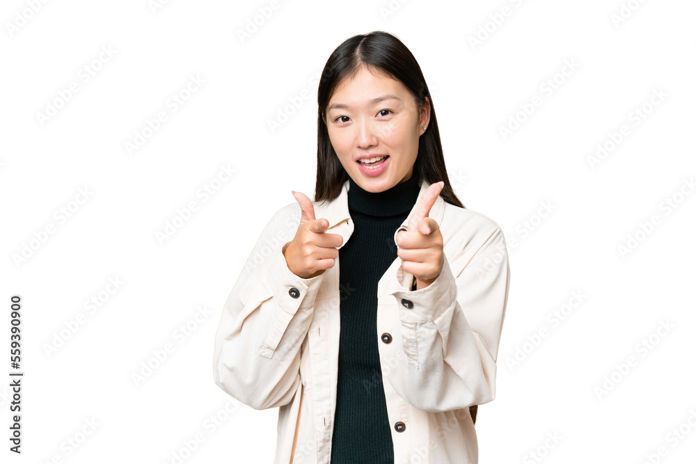 Young Asian woman over isolated chroma key background pointing to the front and smiling