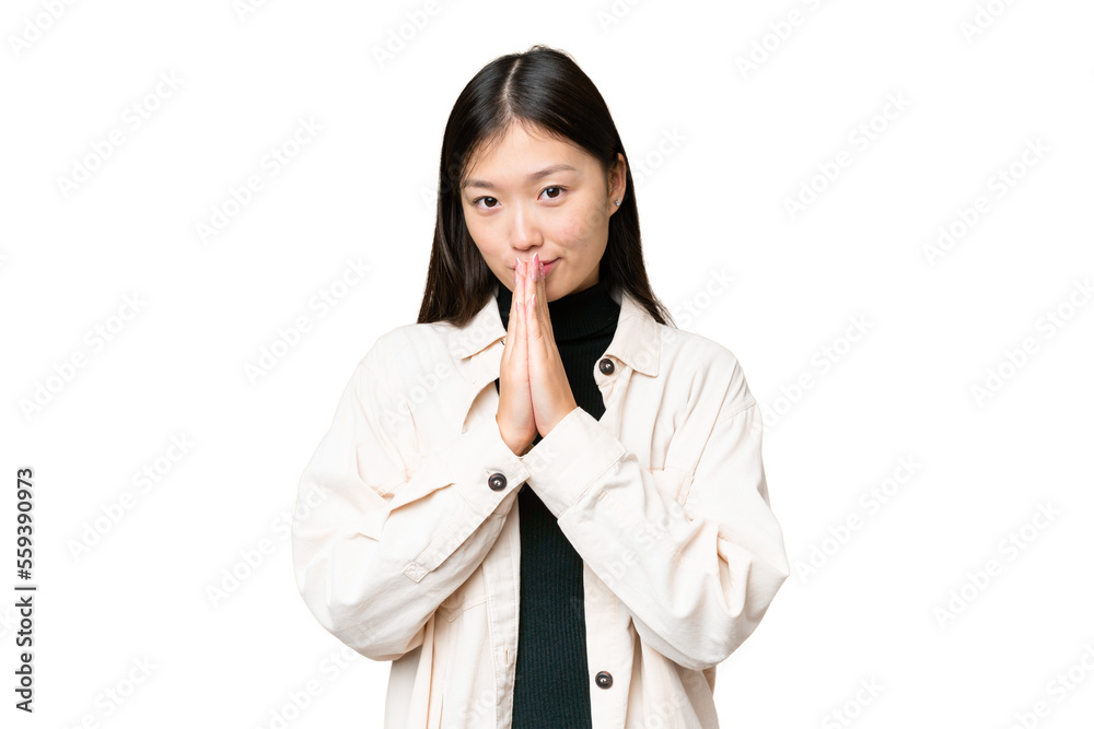 Young Asian woman over isolated chroma key background keeps palm together. Person asks for something Young Asian woman over isolated chroma key background keeps palm together. Person asks for something