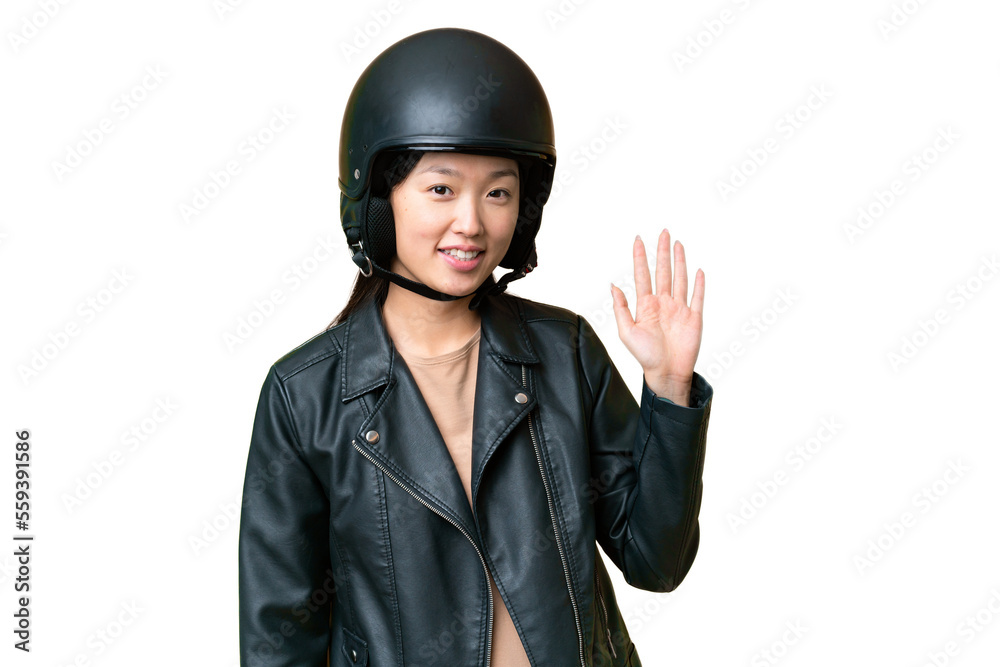 Young Asian woman with a motorcycle helmet over isolated chroma key background saluting with hand with happy expression Young Asian woman with a motorcycle helmet over isolated chroma key background saluting with hand with happy expression