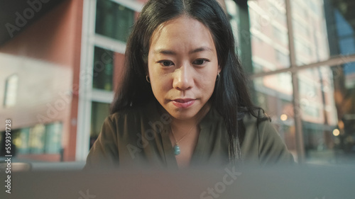 Young woman freelancer working on laptop photo