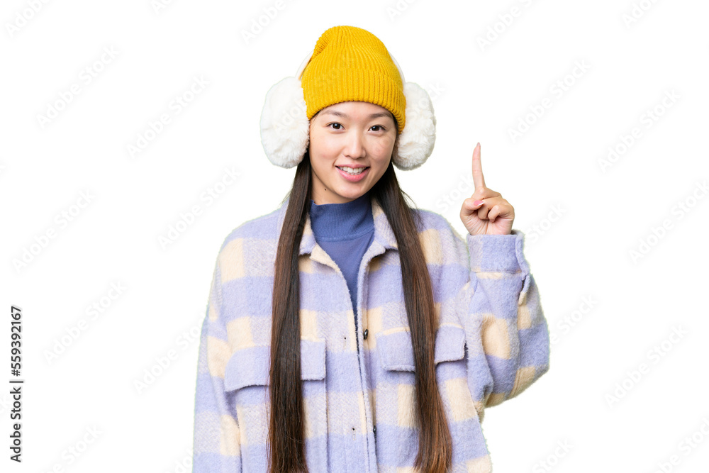 Young Asian woman wearing winter muffs over isolated chroma key background showing and lifting a finger in sign of the best Young Asian woman wearing winter muffs over isolated chroma key background showing and lifting a finger in sign of the best