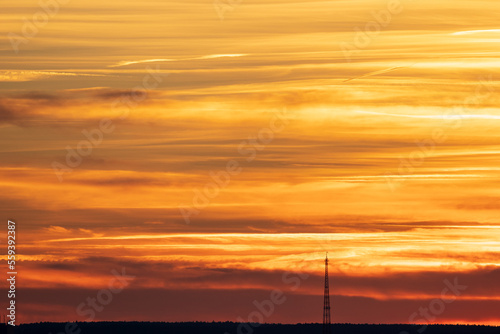 Blue orange sunset on horizon with radio mask in distance