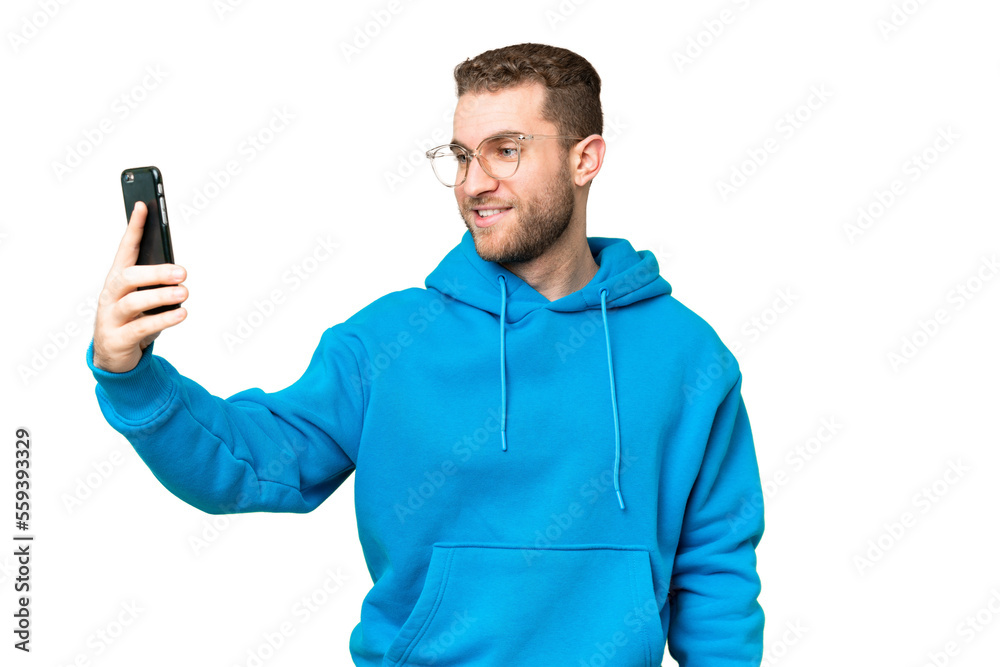 Young handsome blonde man over isolated chroma key background making a selfie Young handsome blonde man over isolated chroma key background making a selfie