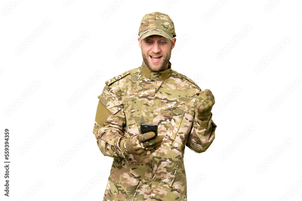 Military man over isolated chroma key background surprised and sending a message Military man over isolated chroma key background surprised and sending a message