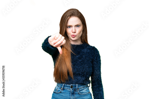 Young pretty woman over isolated chroma key background showing thumb down with negative expression