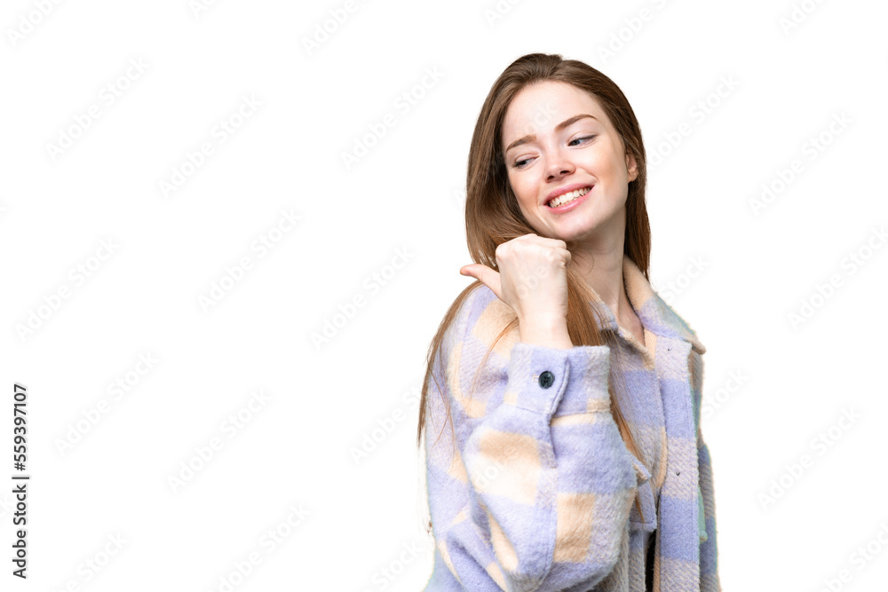Young pretty woman over isolated chroma key background pointing to the side to present a product