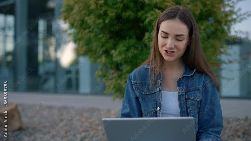 Smiled caucasian student with braces sitting using laptop, having distant lecture, waving at the camera. Female student studying online. People and technology concept Smiled caucasian student with braces sitting using laptop, having distant lecture, waving at the camera. Female student studying online. People and technology concept