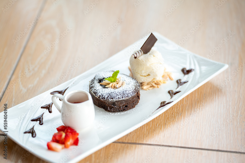 Brownies Steamed brownie with Vanilla, strawberry, chocolate and caramel flavor Ice Cream is a delicious chocolate on a white plate Brownies Steamed brownie with Vanilla, strawberry, chocolate and caramel flavor Ice Cream is a delicious chocolate on a white plate