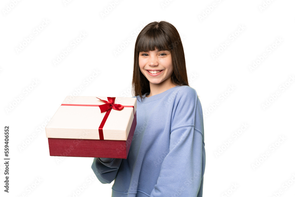 Little girl holding a gift over isolated chroma key background smiling a lot Little girl holding a gift over isolated chroma key background smiling a lot