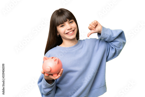 Little girl holding a piggybank over isolated chroma key background proud and self-satisfied