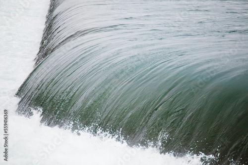 Fresh water in the Niagara River flows smoothly over a concrete step just before Niagara Falls. photo