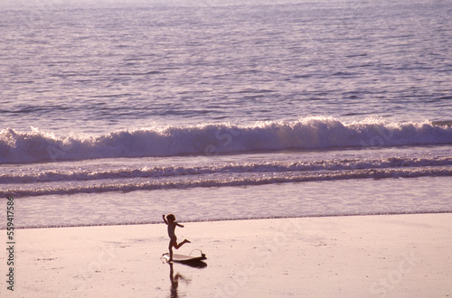 A child runs along the coast of the Pacific Ocean.