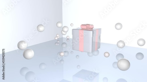 3d animation. A silver gift box with a pink bow floats in the air, balls or bubbles fall on top of the box, scatter and then fly up. Gentle, neutral holiday background.