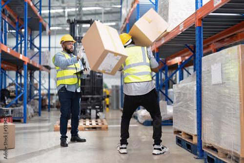 African american working in warehouse got accident from carry box, forklift truck working near by