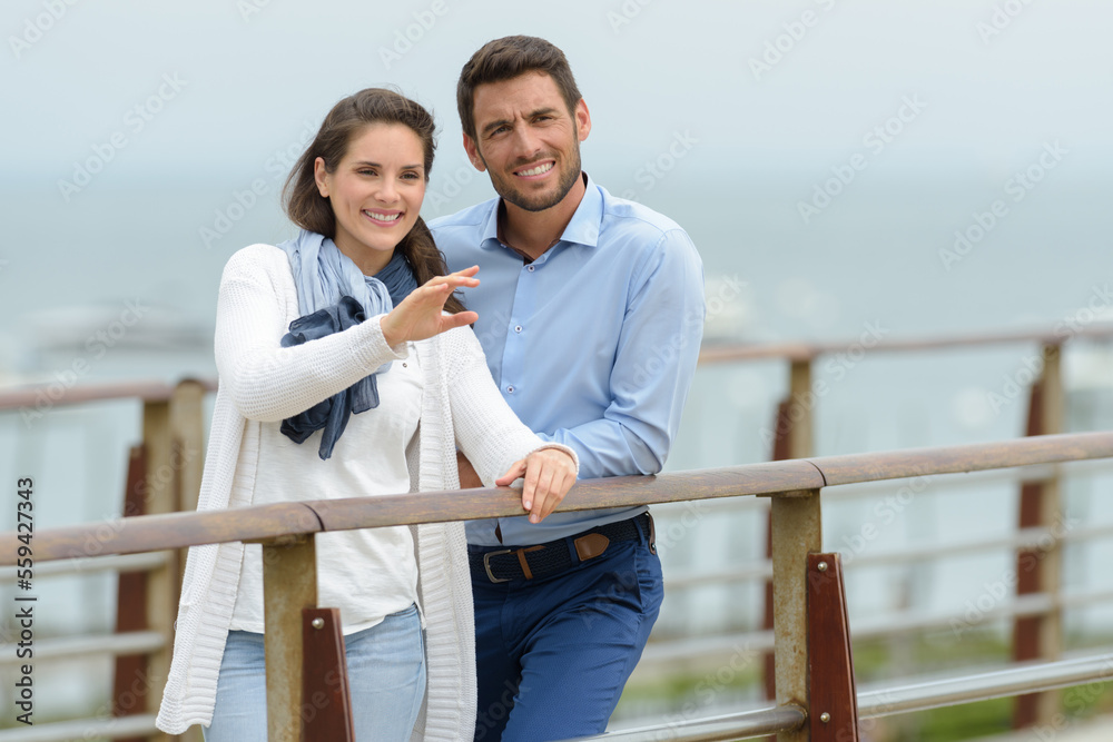 lovers man and woman on a pier on a date