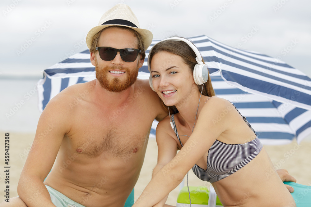 smiling couple holding hands on the beach smiling couple holding hands on the beach