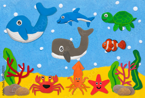 happy sea life animal made from plasticine on sand and sea under water background © warapatr_s