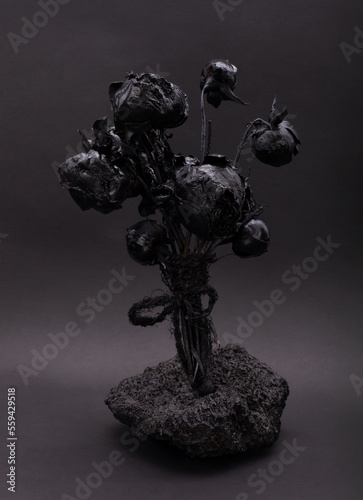 Black gothic bouquet on a black background. Black on black. Dark beauty. Beautiful flowers. Monochrome image.