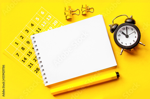 Notepad, clock, calendar, paperclips.. copy space.Top view
