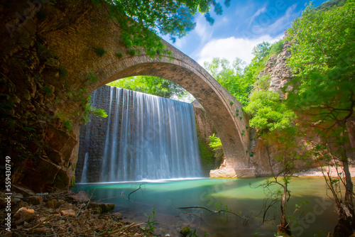 Paleokarya, old, stone, arched bridge, between two waterfalls. Trikala prefecture, Thessaly, Greece photo