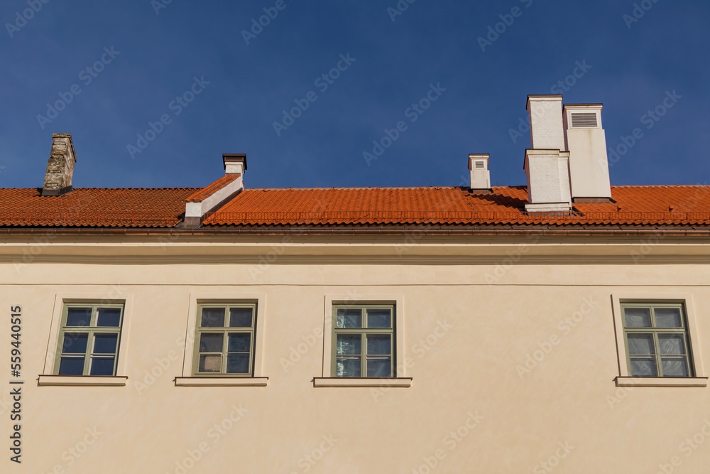 The facade of an old building has been restored and the clay tile roof has been restored The facade of an old building has been restored and the clay tile roof has been restored