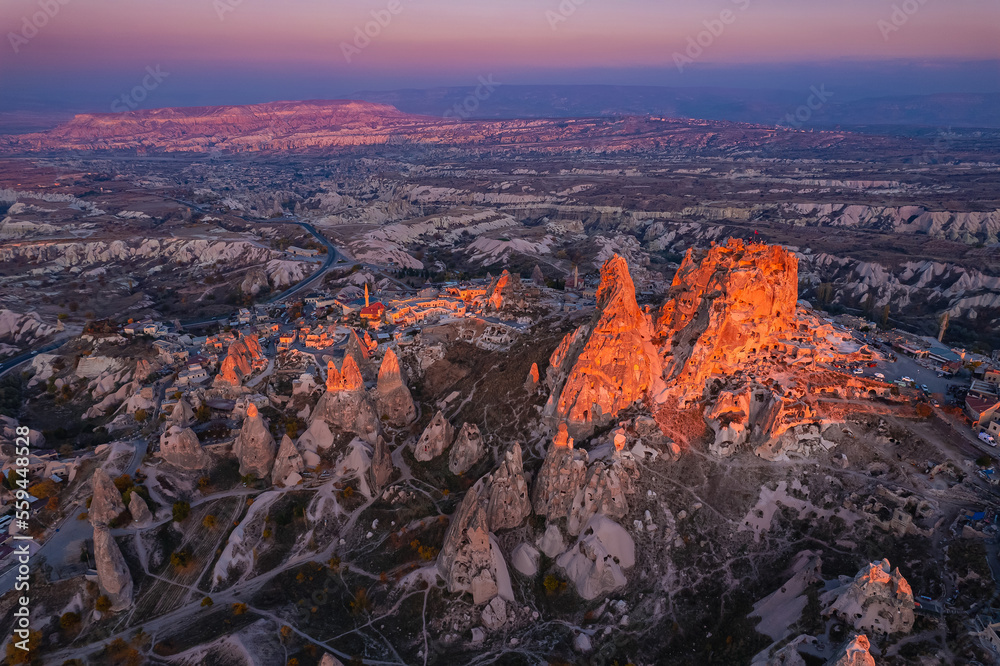 Ancient town of Uchisar castle at sunset Landscape Goreme national park, Cappadocia Turkey, aerial top view