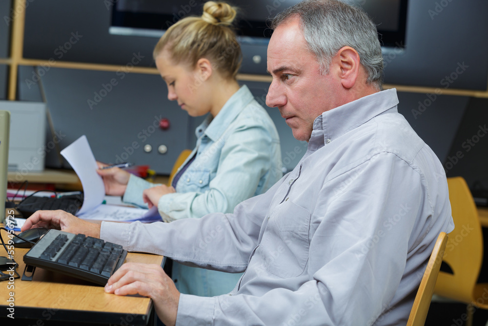 man working with female colleague